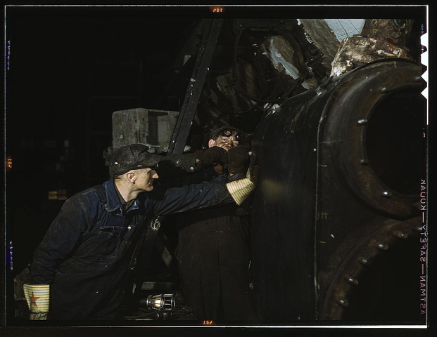 Working on the cylinder of a locomotive at the C & NW RR 40th Street shops, Chicago, Ill.  (LOC)