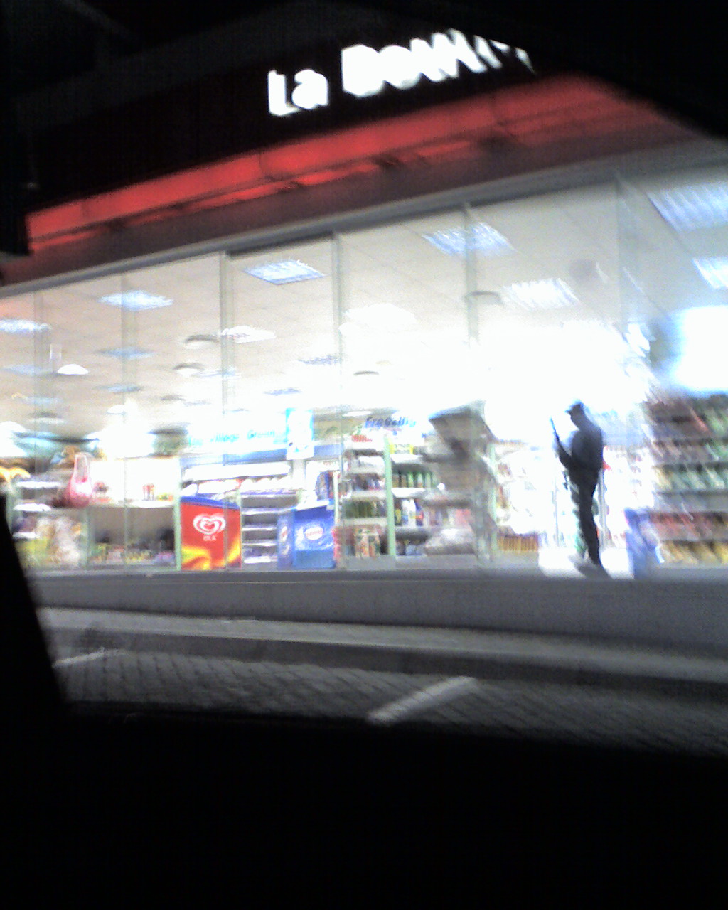 Cameraphone - convenience store - guard with shotgun