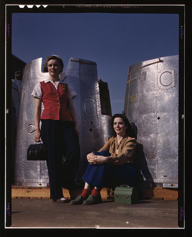 Two assembly line workers at the Long Beach, Calif., plant of Douglas Aircraft Company enjoy a well-earned lunch period, Long Beach, Calif. Nacelle parts of a heavy bomber form the background  (LOC)