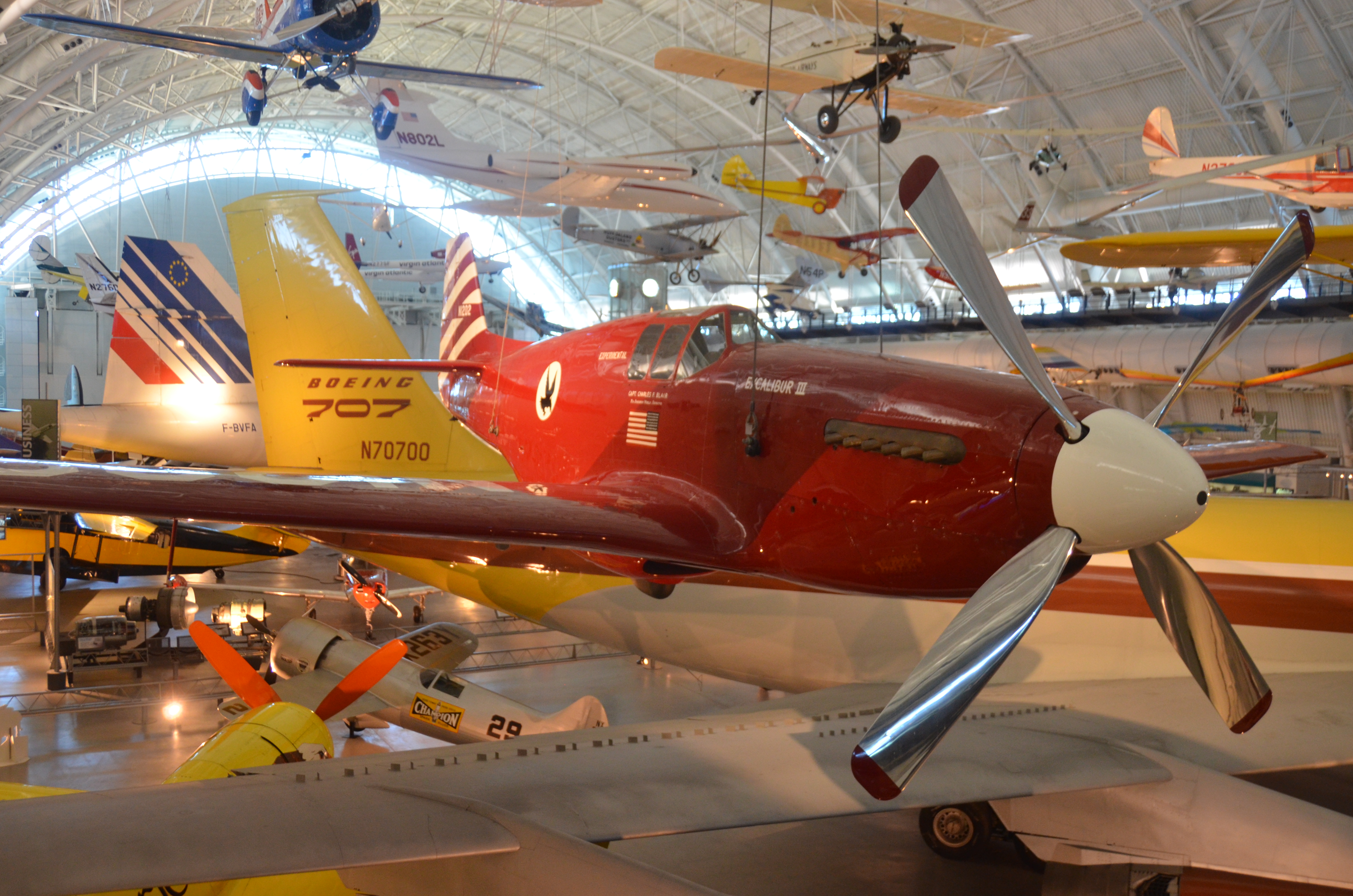 Steven F. Udvar-Hazy Center: North American P-51C, &quot;Excalibur III&quot;, with tails of Concorde &amp; Boeing 707 in background