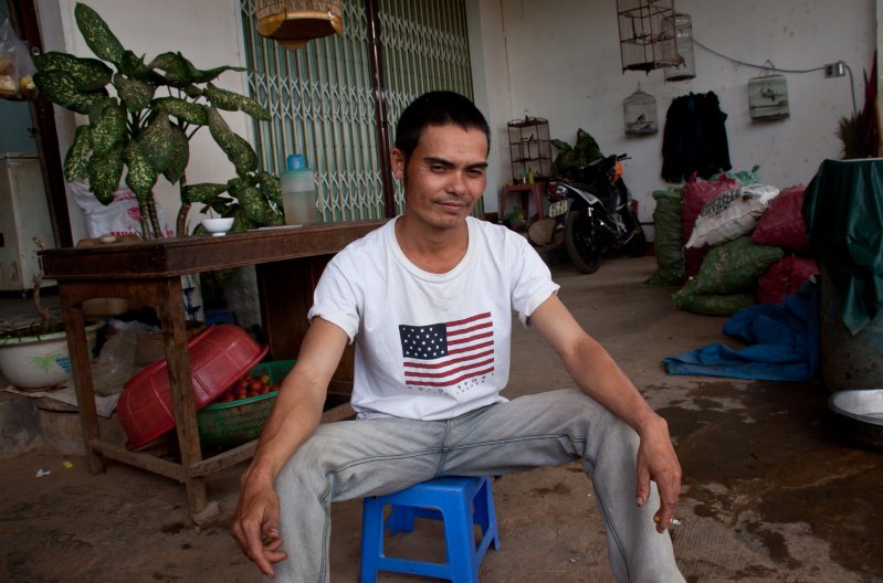Dude Sports a Polo Sport American Flag T-Shirt in Kon Tum Province, Vietnam