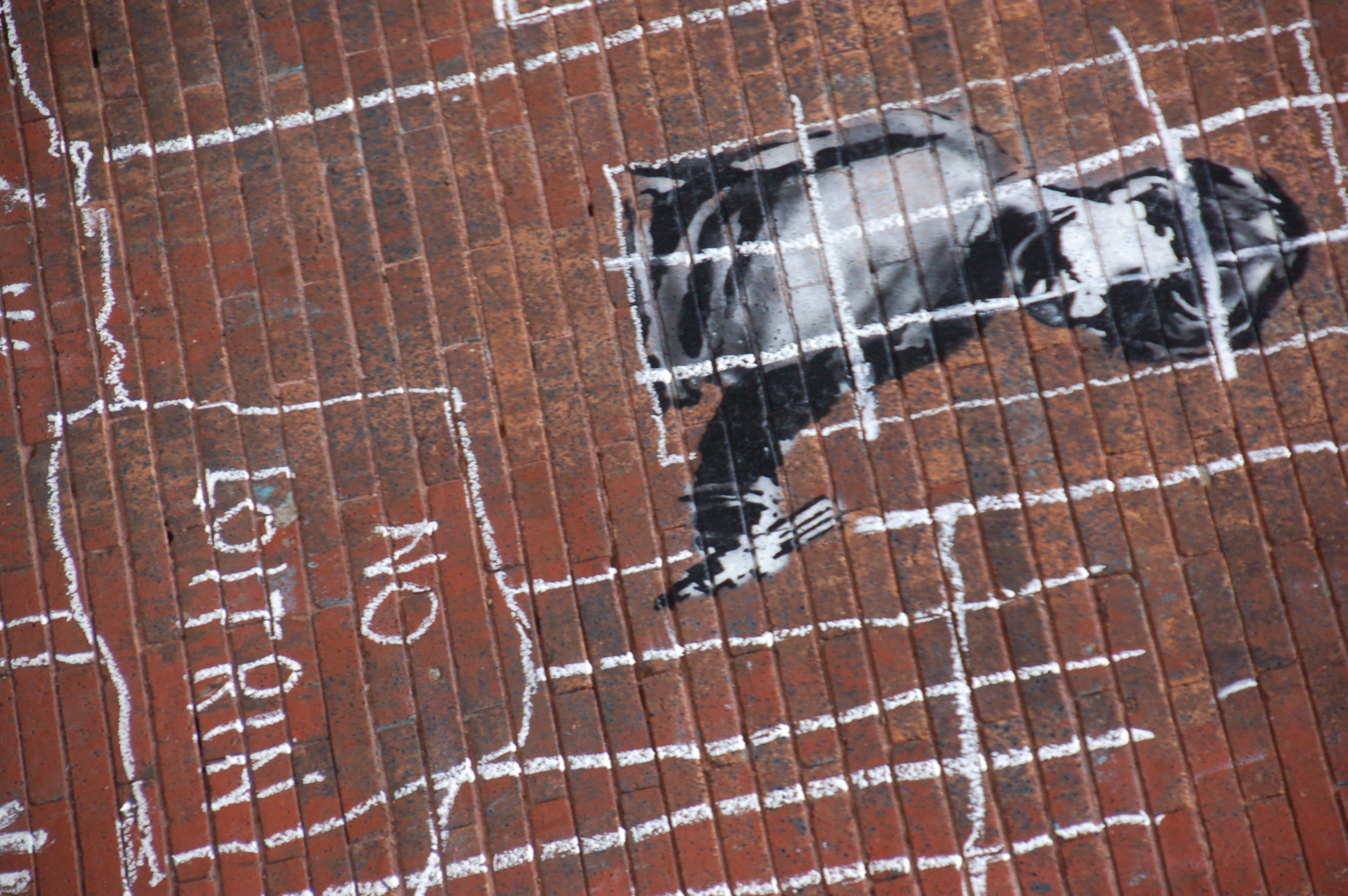 Banksy in Boston: Detail of the NO LOITRIN piece on Essex St in Central Square, Cambridge