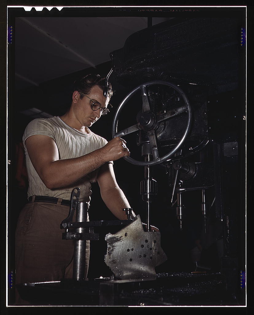 An employee in the drill-press section of North American's huge machine shop runs mounting holes in a large dural casting, Inglewood, Calif. This plant produces the battle-tested B-25 ("Billy Mitchell") bomber, used in General Doolittle's raid on Tokyo, a