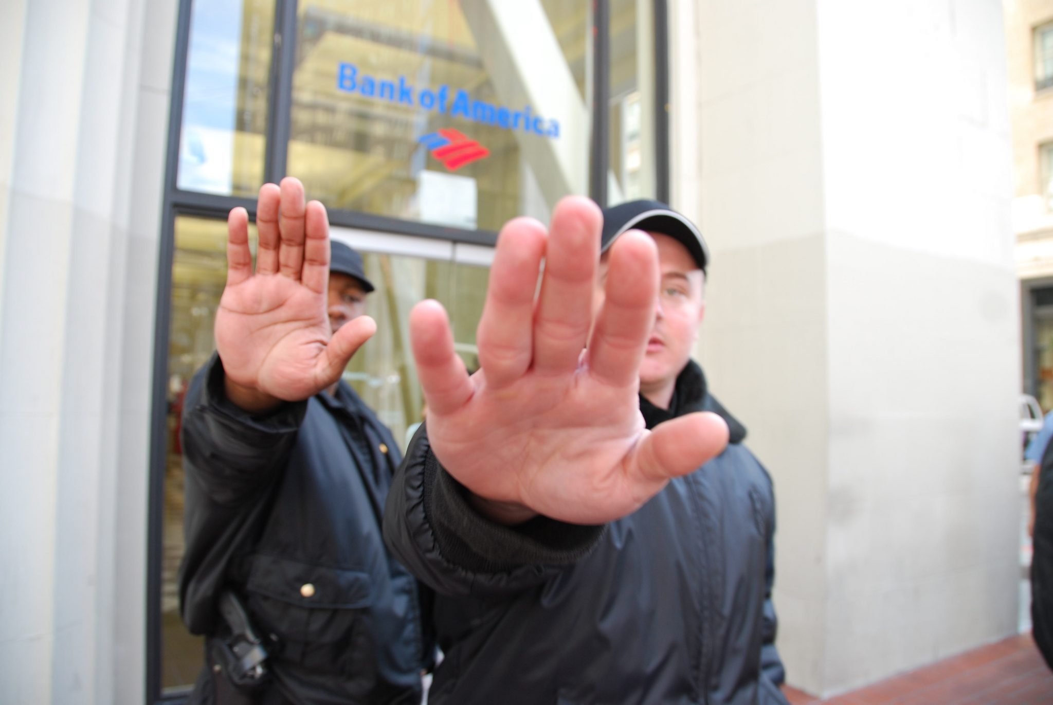 Bank of America security trying to prevent me from taking a photo during the Iraq war protest by Steve Rhodes / CC BY-NC-SA 2.0 Bank of America security trying to prevent me from taking a photo during the Iraq war protest